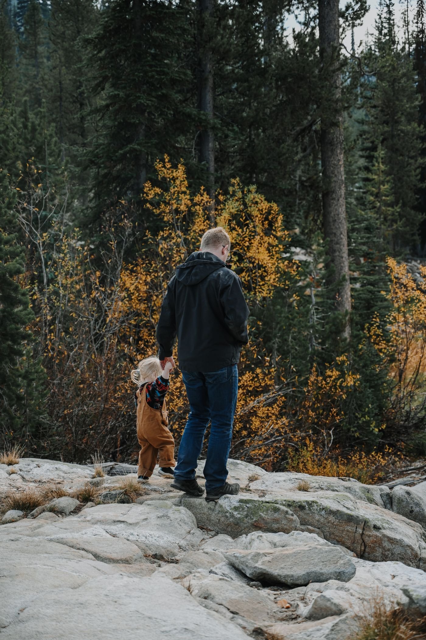 Father and child exploring an autumn forest