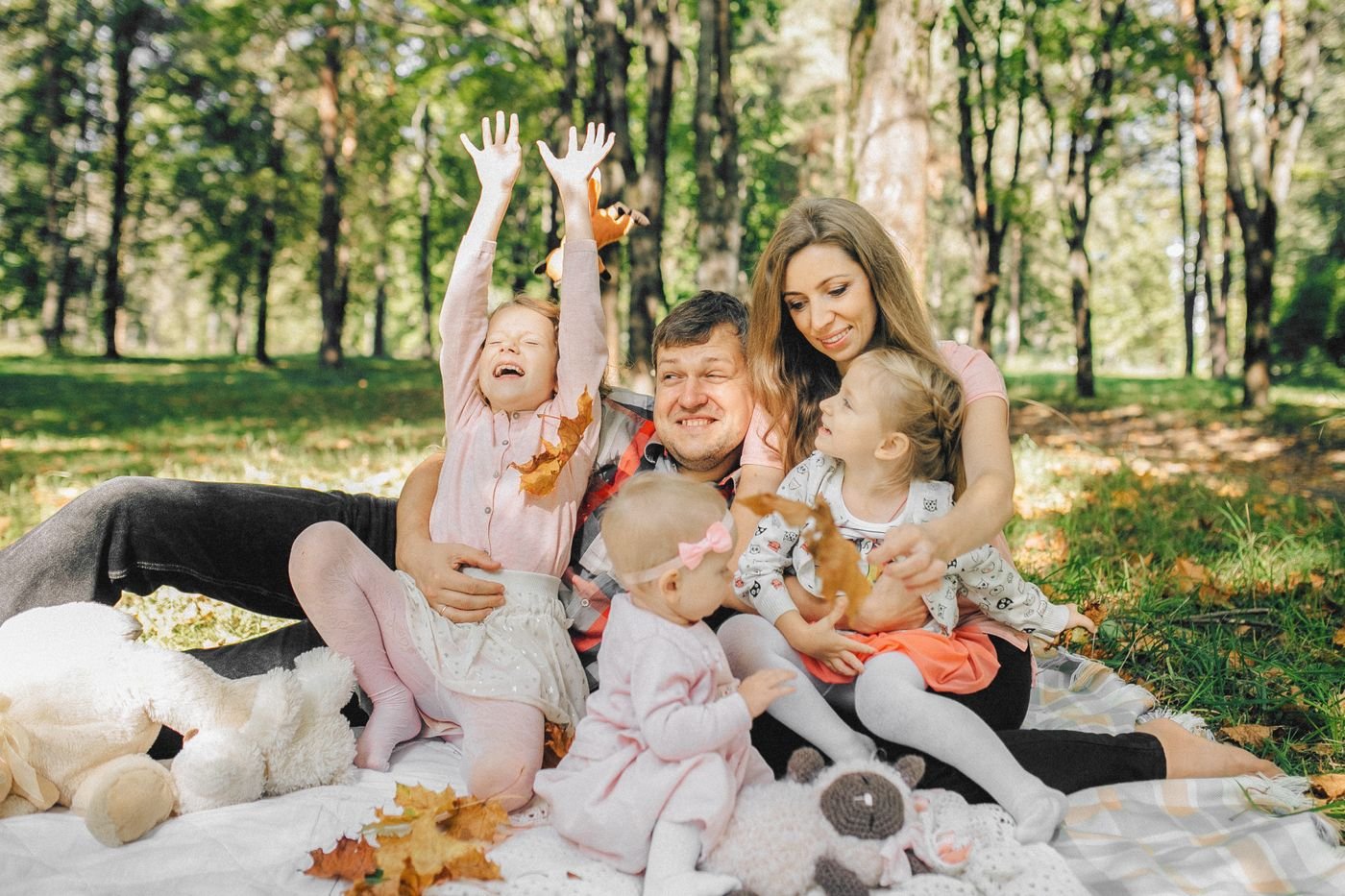 A family sharing a picnic in a leafy park